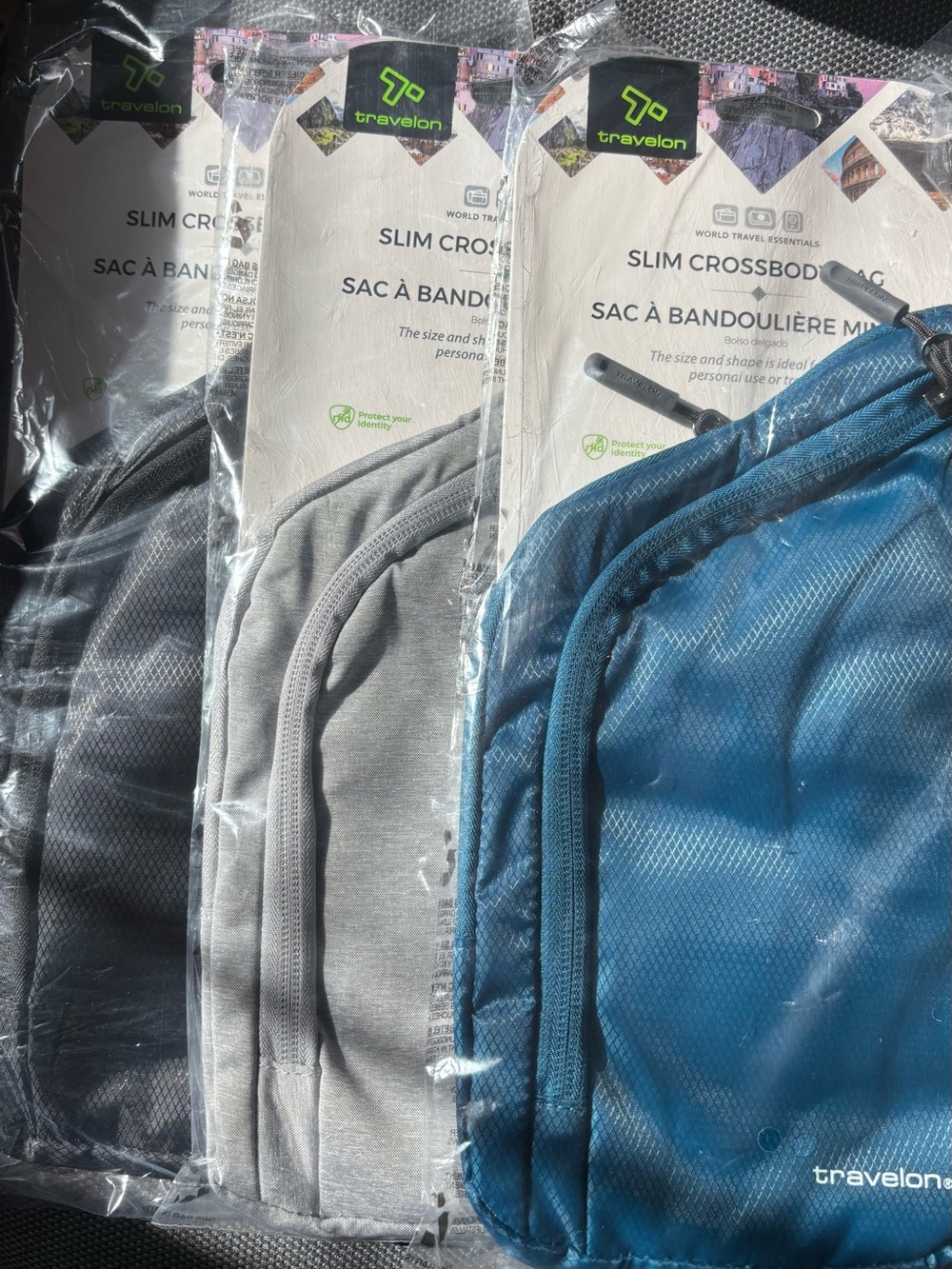 Travelon Slim Crossbody Pack in Blue, Gray & Black.  ***Each sold separately**
